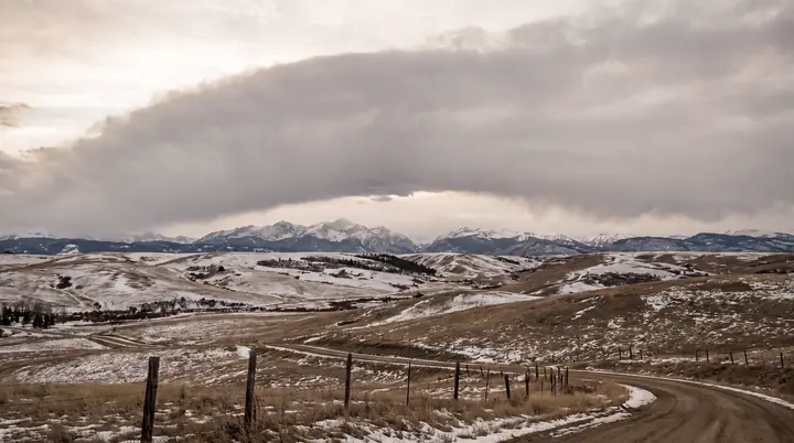 Foothills west of Calgary in late winter under a chinook arch.